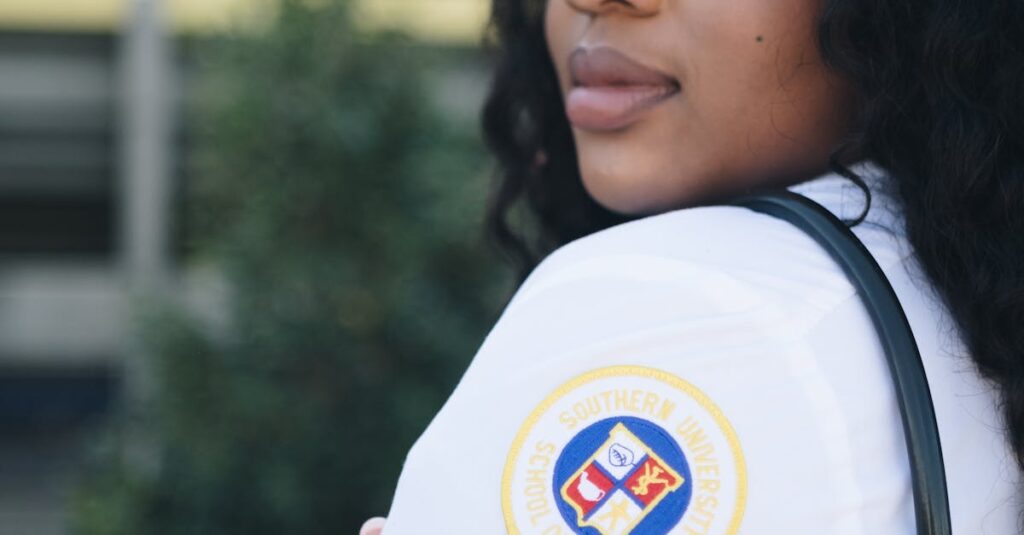 Confident nursing graduate posing outdoors in Baton Rouge with stethoscope and cap.